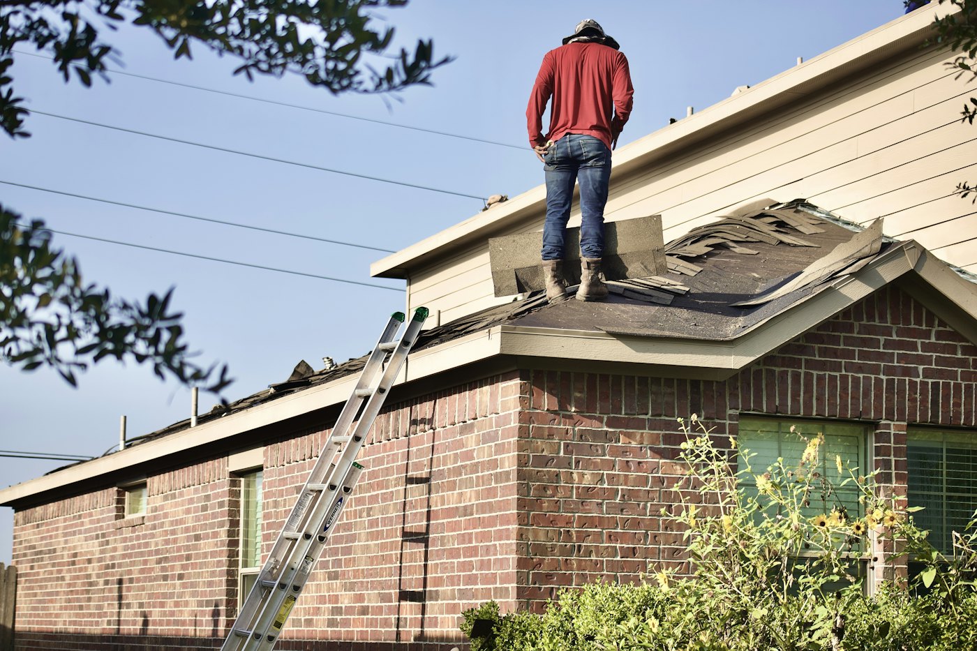 Roofer working on a house roof